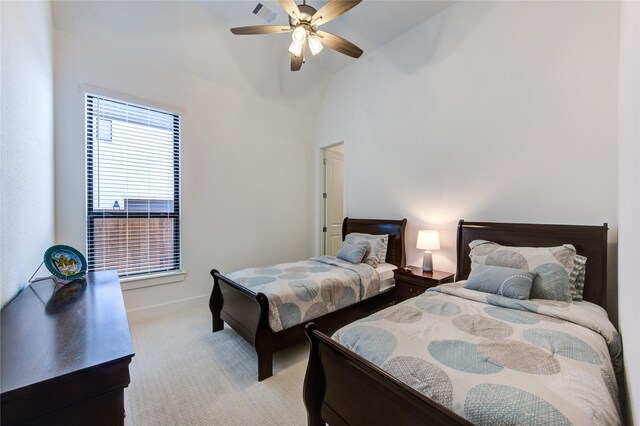 bedroom featuring visible vents, light carpet, baseboards, a ceiling fan, and vaulted ceiling
