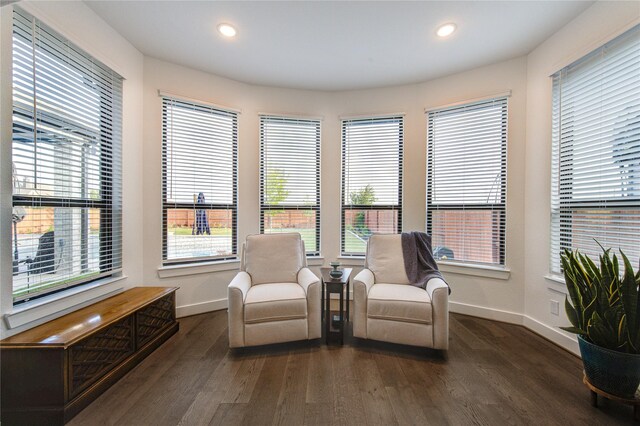 living area featuring recessed lighting, baseboards, dark wood-style floors, and a healthy amount of sunlight