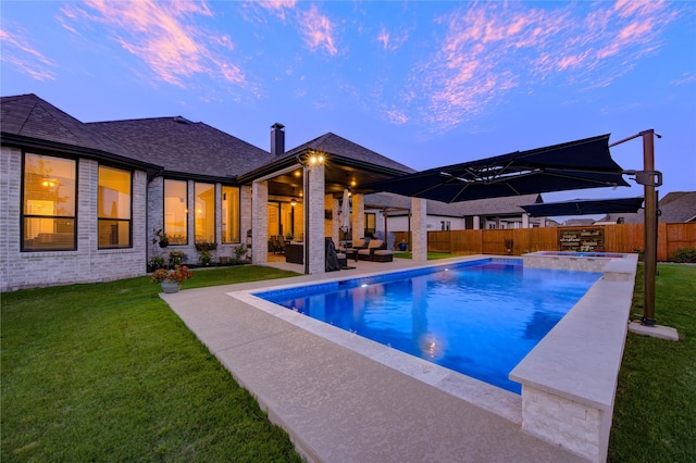 view of swimming pool with a fenced backyard, an outdoor hangout area, a patio area, a pool with connected hot tub, and a yard