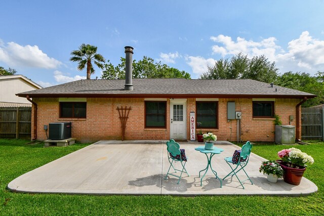 back of house with brick siding, central AC unit, a patio area, and fence