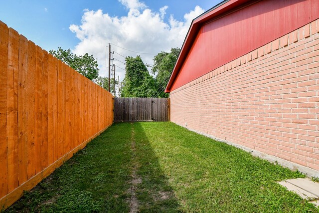 view of yard with a fenced backyard