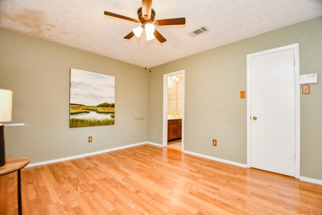 unfurnished room featuring baseboards, ceiling fan, light wood-style flooring, and visible vents