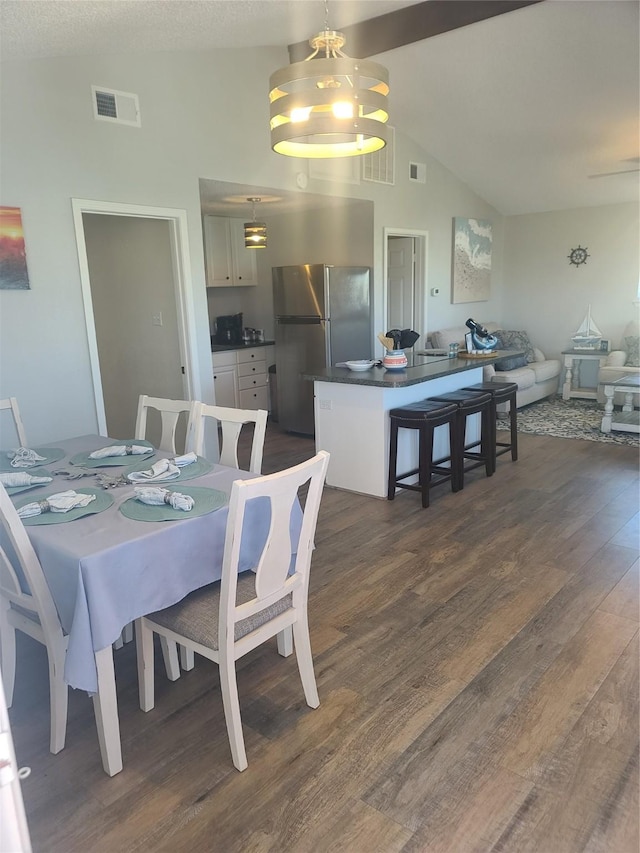 4222 Mason Dr, Galveston, TX 77554 - dining room with a chandelier, visible vents, vaulted ceiling with beams, and dark wood-type flooring