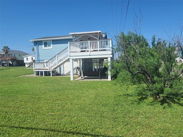 4222 Mason Dr, Galveston, TX 77554 - rear view of property with stairs, a deck, and a yard