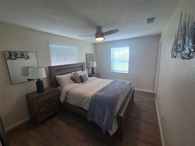 4222 Mason Dr, Galveston, TX 77554 - bedroom with a textured ceiling, visible vents, dark wood finished floors, a ceiling fan, and baseboards