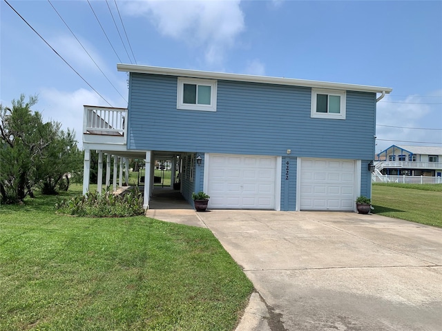 4222 Mason Dr, Galveston, TX 77554 - view of front of house with a balcony, a front yard, an attached garage, and driveway