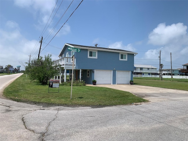 4222 Mason Dr, Galveston, TX 77554 - view of front of property featuring a balcony, a garage, a front lawn, and driveway
