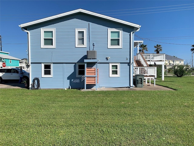 4222 Mason Dr, Galveston, TX 77554 - back of house featuring a lawn and stairway