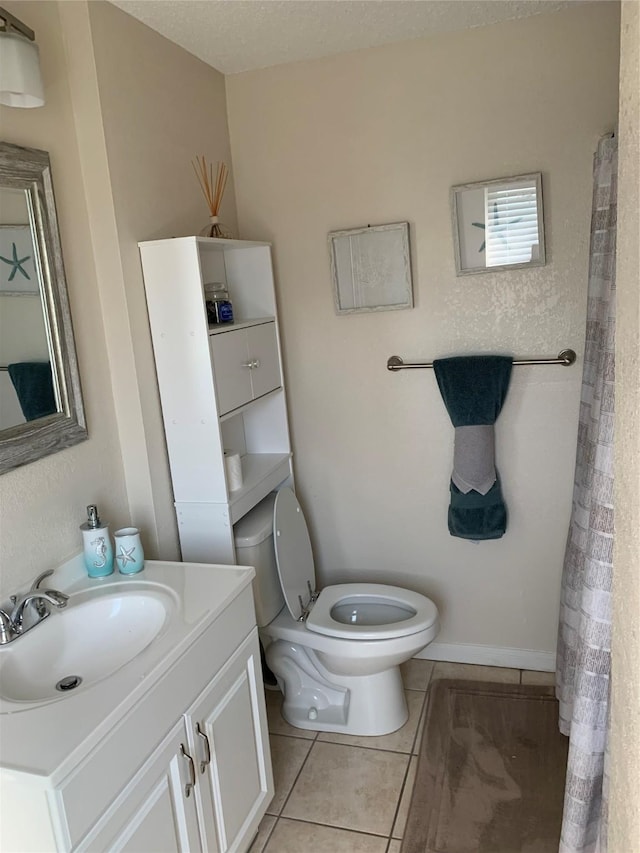 4222 Mason Dr, Galveston, TX 77554 - bathroom with vanity, toilet, and tile patterned floors