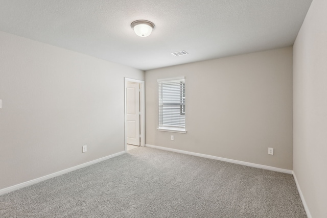 unfurnished room featuring carpet floors, baseboards, and visible vents