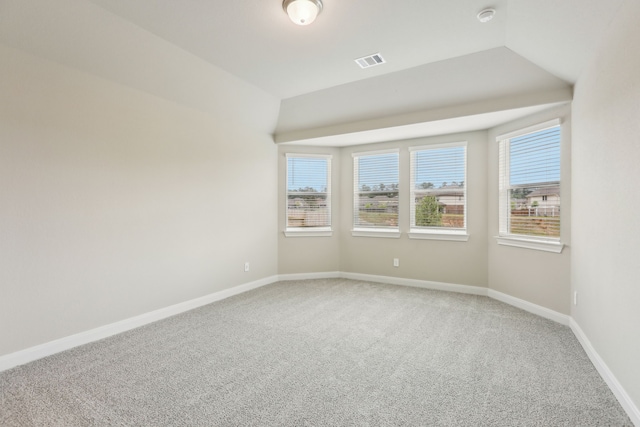 spare room featuring a healthy amount of sunlight, baseboards, and light colored carpet