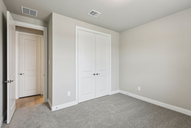 1631 Shae Oak Ln, Conroe, TX 77304 - unfurnished bedroom featuring carpet, baseboards, a closet, and visible vents