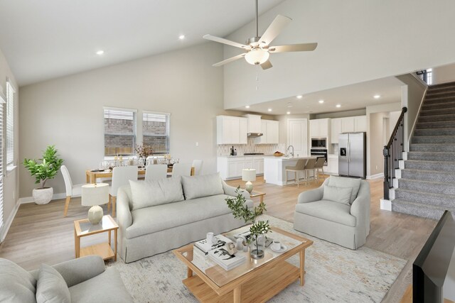 1631 Shae Oak Ln, Conroe, TX 77304 - living area with stairway, light wood-style flooring, baseboards, and a ceiling fan