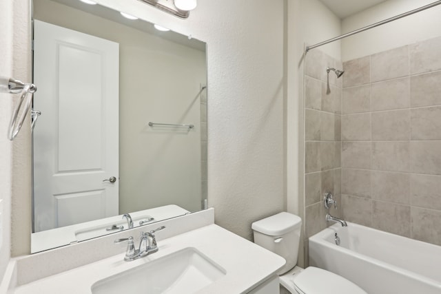 full bathroom featuring vanity, a textured wall, toilet, and  shower combination