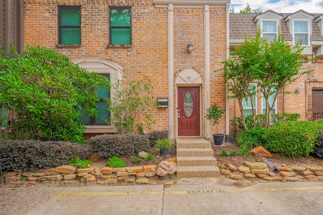property entrance with brick siding