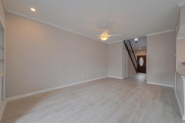 unfurnished room featuring crown molding, a ceiling fan, baseboards, and light wood finished floors