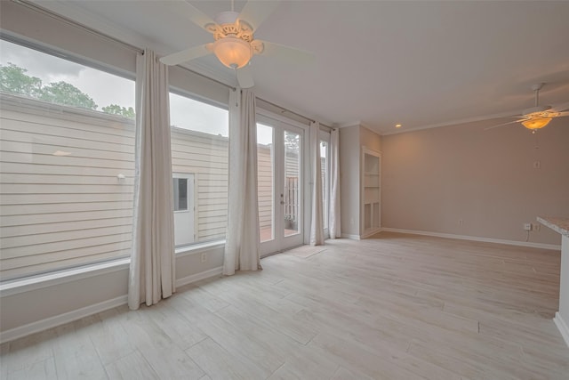 empty room featuring baseboards, ornamental molding, light wood-style flooring, and ceiling fan
