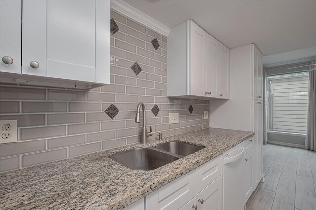 15171 Kimberley Ct Unit 43, Houston, TX 77079 - kitchen featuring a sink, dishwasher, tasteful backsplash, and white cabinetry