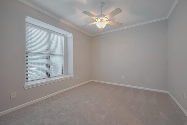spare room with baseboards, ornamental molding, light carpet, and a ceiling fan