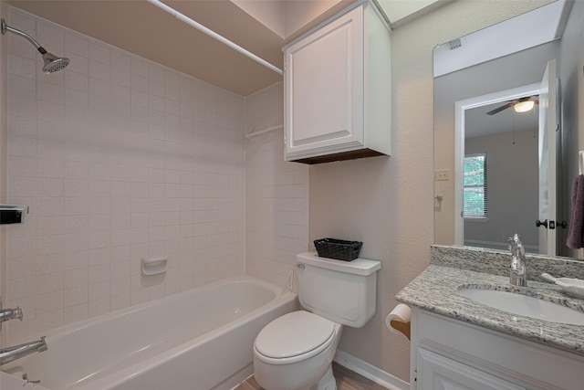 full bath with vanity, toilet, baseboards, ceiling fan, and  shower combination