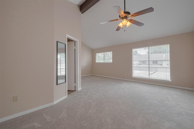 spare room with baseboards, vaulted ceiling with beams, ceiling fan, and light colored carpet