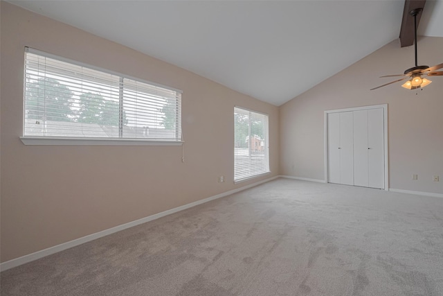 carpeted spare room with baseboards, ceiling fan, beam ceiling, and high vaulted ceiling