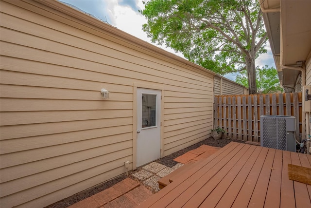 deck featuring central air condition unit and fence
