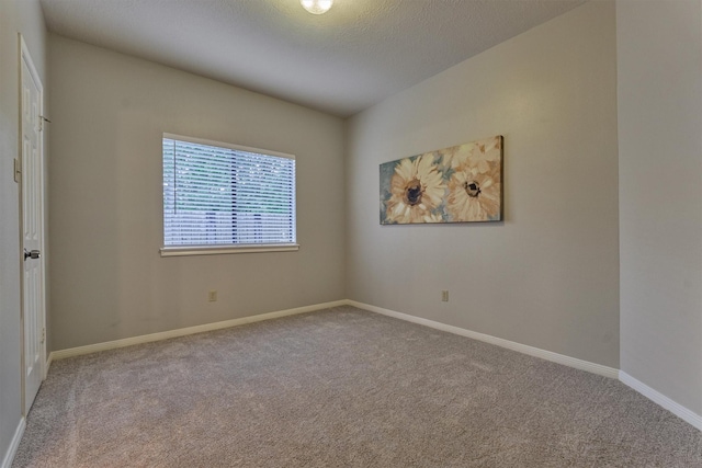 carpeted empty room with baseboards