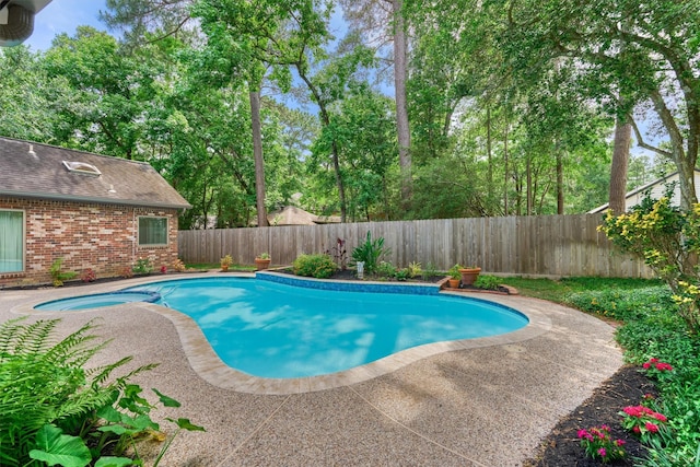 view of pool with a fenced backyard, a patio, and a pool with connected hot tub