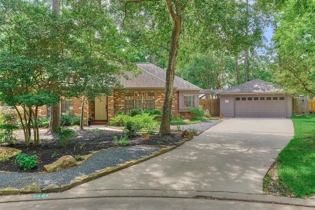 view of front facade featuring roof with shingles, a garage, brick siding, fence, and concrete driveway