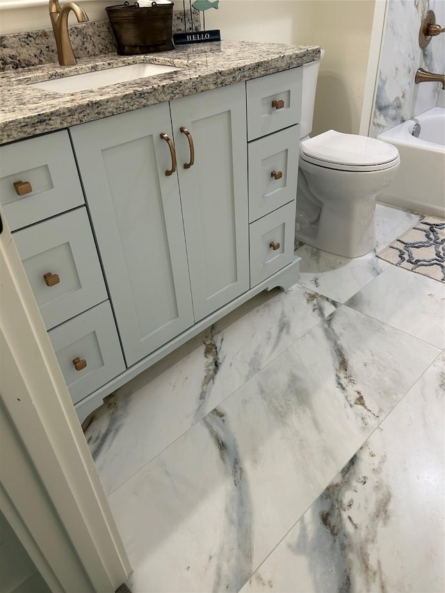 bathroom with vanity, marble finish floor, and toilet