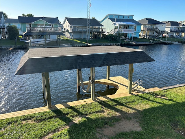 view of dock with a water view, boat lift, and a residential view