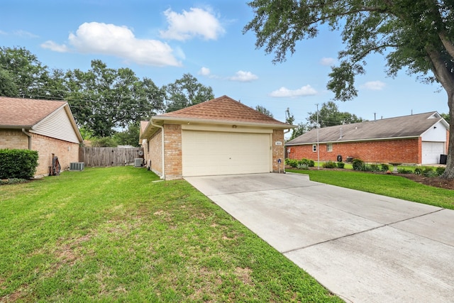 view of side of home featuring fence, central AC unit, a yard, and brick siding