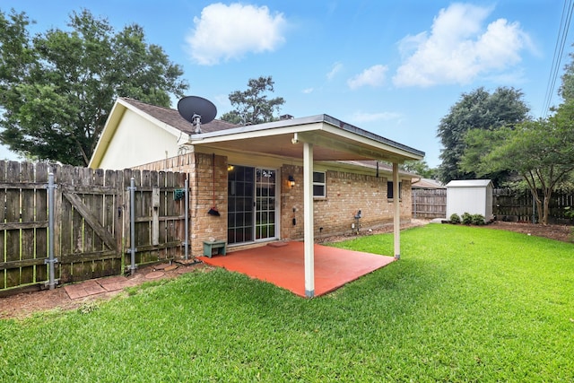back of house with a lawn, a patio area, brick siding, a fenced backyard, and a shed
