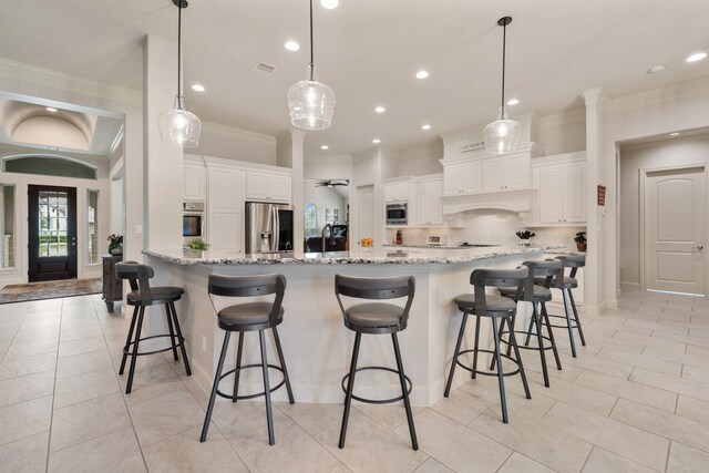 kitchen featuring appliances with stainless steel finishes, ornamental molding, backsplash, and light stone counters
