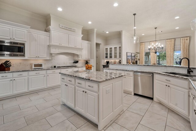 kitchen featuring a sink, appliances with stainless steel finishes, decorative backsplash, and recessed lighting