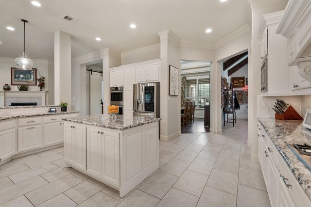 kitchen with crown molding, stainless steel appliances, recessed lighting, and visible vents