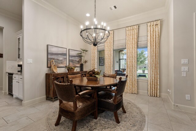 dining room with crown molding, baseboards, visible vents, and a notable chandelier