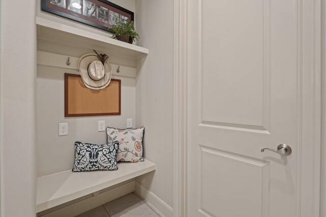 mudroom featuring tile patterned floors and baseboards