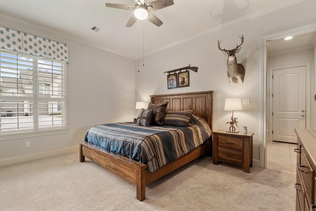 bedroom with light colored carpet, baseboards, crown molding, and visible vents