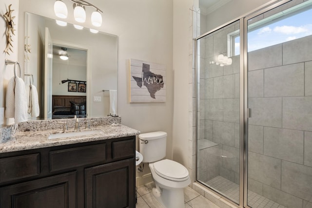 ensuite bathroom with toilet, a shower stall, ensuite bathroom, and vanity