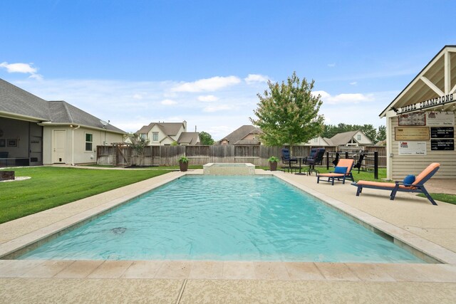 view of pool featuring a lawn, a pool with connected hot tub, a residential view, a patio area, and a fenced backyard