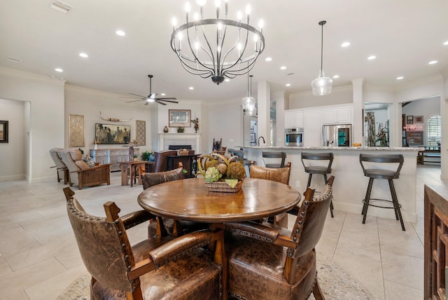 dining space with recessed lighting, ornamental molding, ceiling fan with notable chandelier, and visible vents