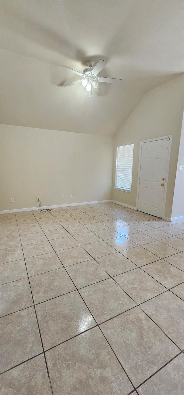 unfurnished room with light tile patterned flooring, ceiling fan, baseboards, and lofted ceiling