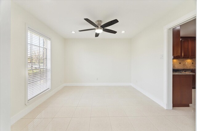 spare room with a ceiling fan, baseboards, and recessed lighting