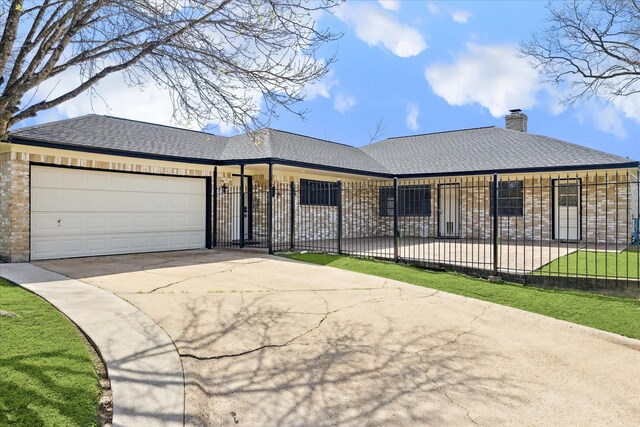 ranch-style home with fence private yard, a garage, a chimney, brick siding, and concrete driveway