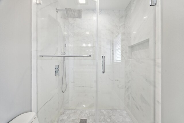 bathroom featuring toilet, visible vents, and a marble finish shower