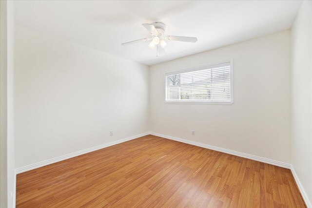 unfurnished room with baseboards, light wood finished floors, and ceiling fan