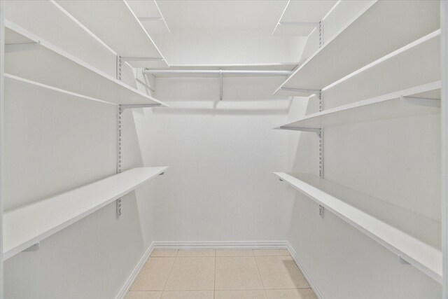 spacious closet featuring light tile patterned flooring