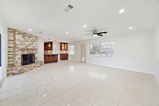 unfurnished living room with visible vents, recessed lighting, ceiling fan, and a fireplace